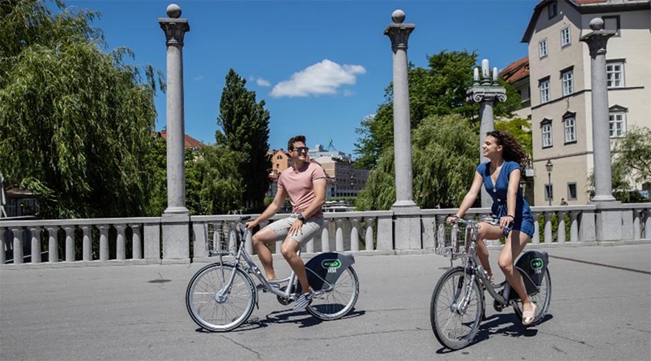 A young couple cycling in the streets of Ljubljana